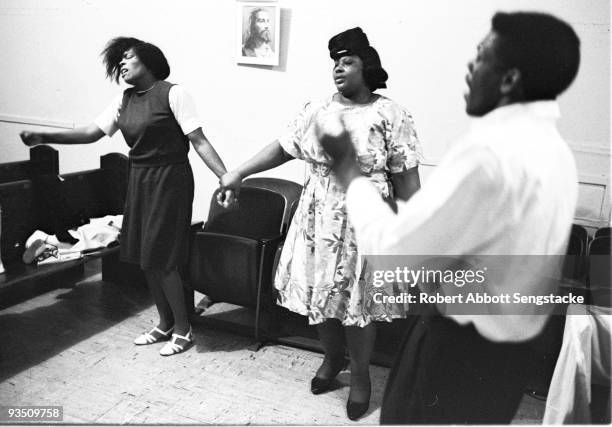 View of church goers dancing and singing while participating in a religious service at the Temple Apostolic Church, a storefront church in Chicago,...