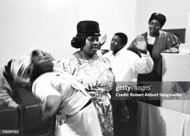 View of church goers dancing and singing while participating in a religious service at the Temple Apostolic Church, a storefront church in Chicago,...