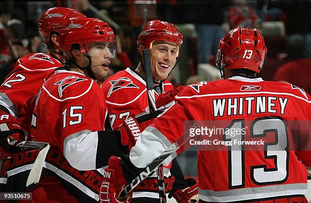 Joe Corvo of the Carolina Hurricanes celebrates his first period goal with teammates Eric Staal, Tuomo Ruutu and Ray Whitney during a NHL game...
