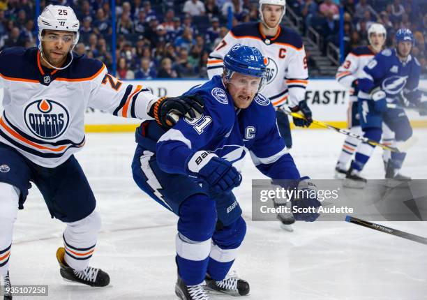 Steven Stamkos of the Tampa Bay Lightning skates against Darnell Nurse of the Edmonton Oilers during the first period at Amalie Arena on March 18,...