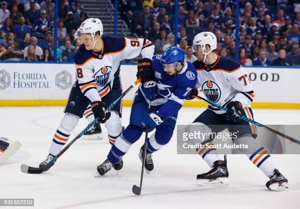 Anthony Cirelli of the Tampa Bay Lightning skates against Jesse Puljujarvi and Oscar Klefbom of the Edmonton Oilers during the first period at Amalie...