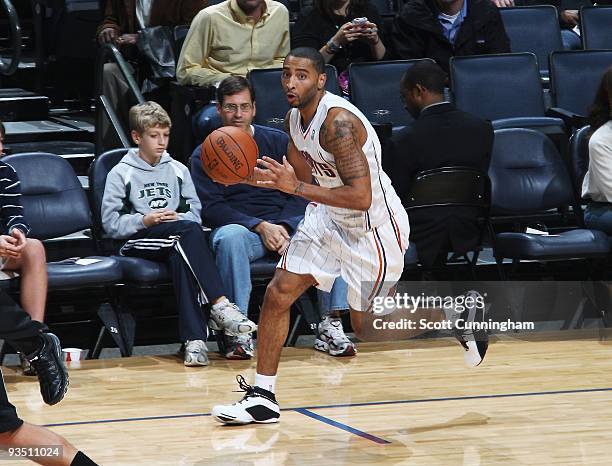 Acie Law of the Charlotte Bobcats moves the ball against the Toronto Raptors during the game on November 25, 2009 at the Time Warner Cable Arena in...
