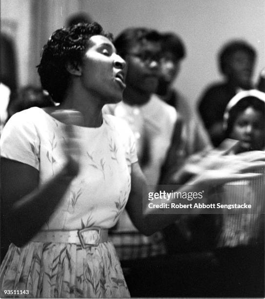 View of church goers dancing and singing while participating in a religious service at the Temple Apostolic Church, a storefront church in Chicago,...