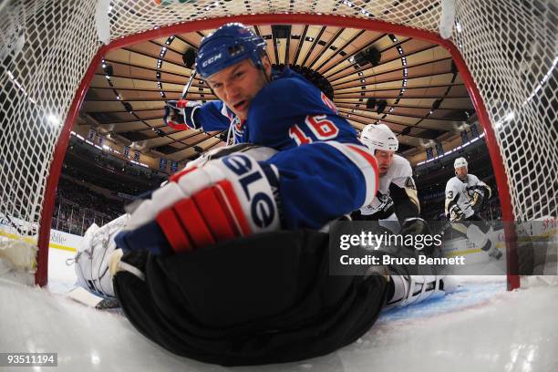 Brooks Orpik of the Pittsburgh Penguins propels Sean Avery of the New York Rangers over goaltender Marc-Andre Fleury at Madison Square Garden on...