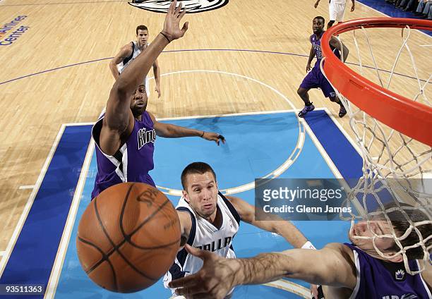 Jose Barea of the Dallas Mavericks shoots a layup against Kenny Thomas and Beno Udrih of the Sacramento Kings during the game at American Airlines...