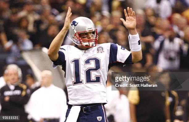 Quarterback Tom Brady of the New England Patriots gestures how far they are from a first down after a third down play during the first quarter of the...