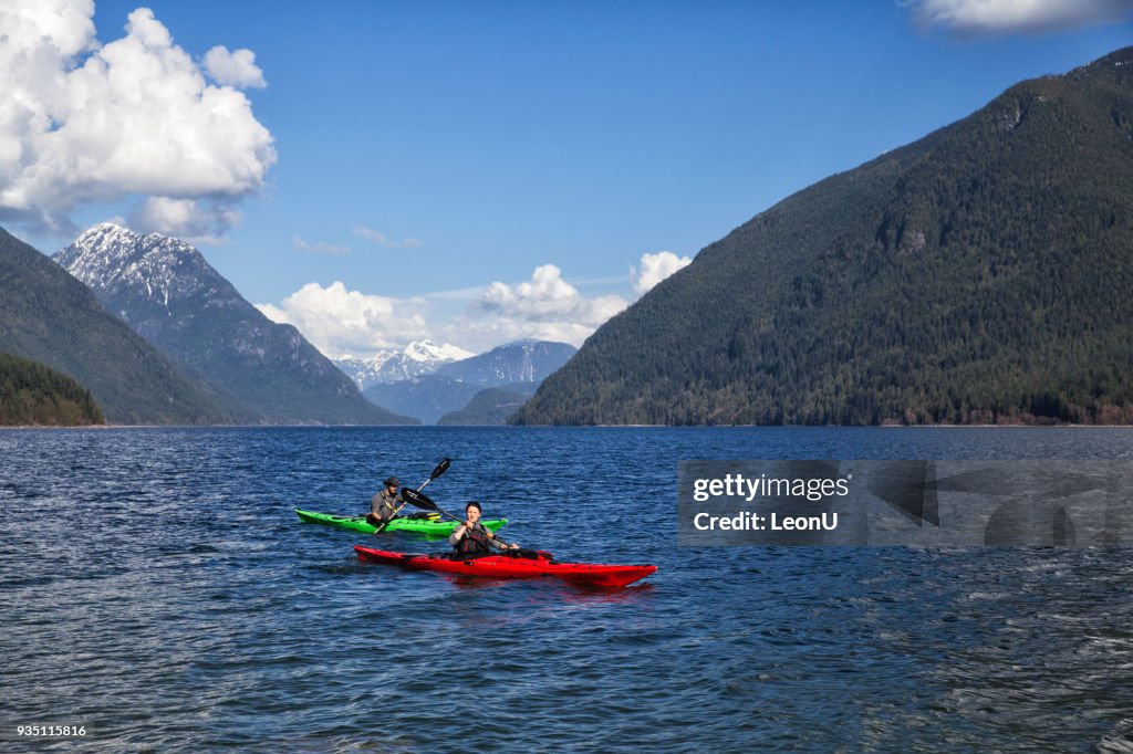 Couple kayaking at Alouette Lake, BC, Canada
