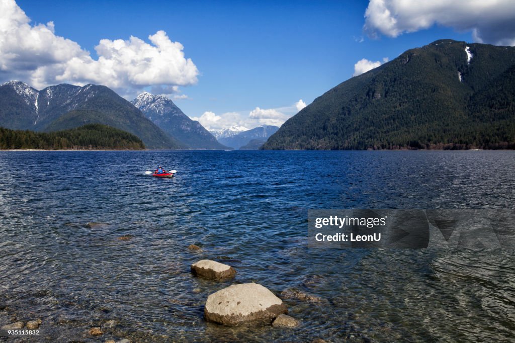 Young woman kayaking at Alouette Lake, BC, Canada