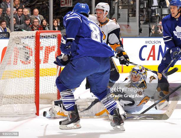 Phil Kessel of the Toronto Maple Leafs is stopped in close by Ryan Miller of the Buffalo Sabres during game action November 30, 2009 at the Air...