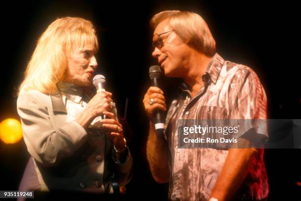 American country music singer-songwriter Tammy Wynette and American musician, singer and songwriter George Jones perform together during a concert...