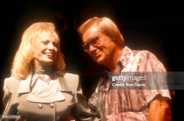 American country music singer-songwriter Tammy Wynette and American musician, singer and songwriter George Jones perform together during a concert...