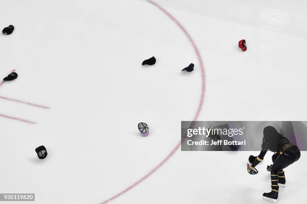 Member of the Knights Crew cleans hats off the ice after William Karlsson of the Vegas Golden Knights scored his third goal of the second period...