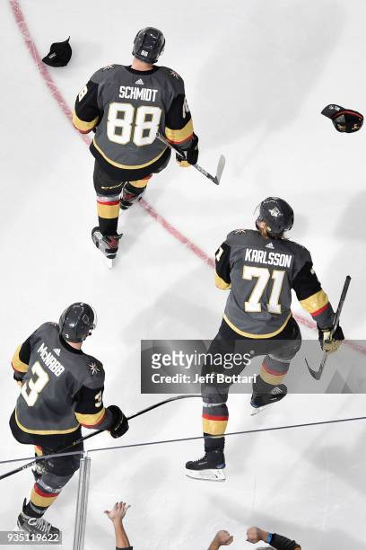 William Karlsson records a hat trick and skates back to the bench with his teammates Brayden McNabb and Nate Schmidt of the Vegas Golden Knights...