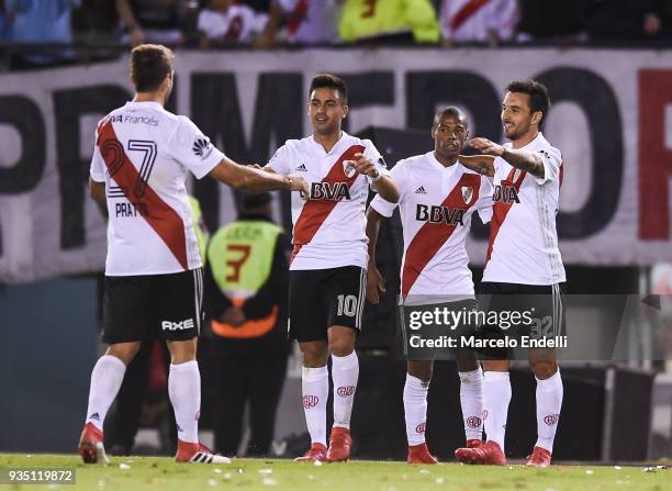 Ignacio Scocco of River Plate celebrates with teammates after scoring the third goal of his team during a match between River Plate and Belgrano as...