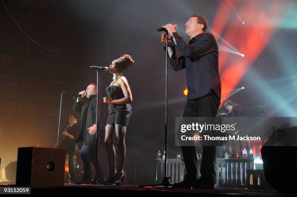 Charlie Burchill, Jim Kerr and Andy McCluskey of Simple Minds and OMD perform on stage during a joint rendition of Kraftwerk's 'Neon Lights' on...