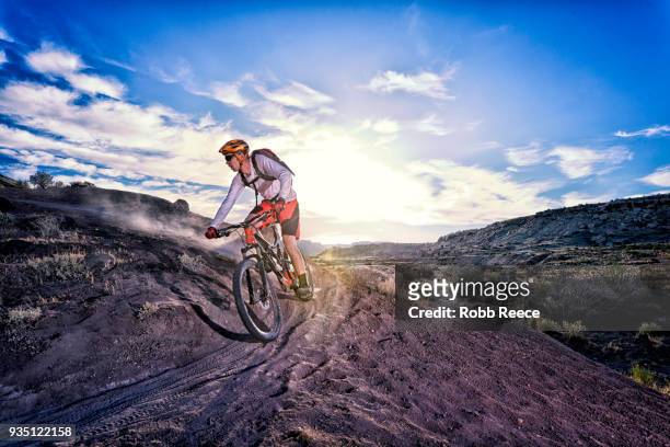 a man riding a mountain bike on an extreme dirt trail - robb reece stockfoto's en -beelden