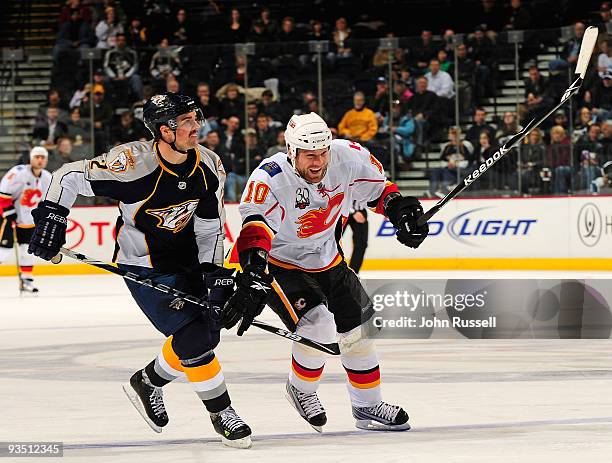 Dan Hamhuis of the Nashville Predators skates against Brian McGrattan of the Calgary Flames on November 30, 2009 at the Sommet Center in Nashville,...