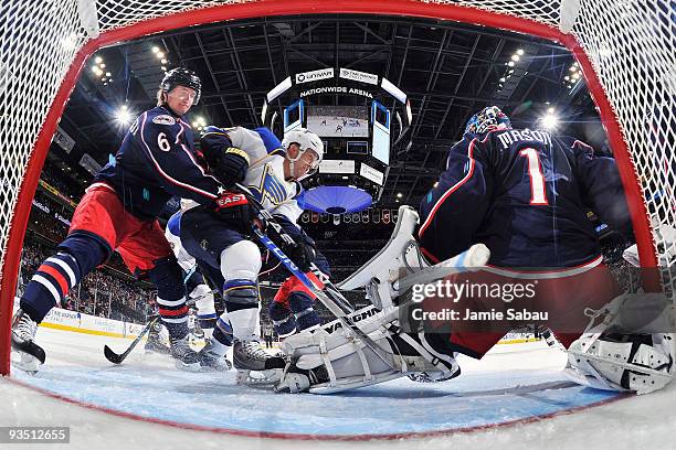 Anton Stralman of the Columbus Blue Jackets defends against Andy McDonald of the St. Louis Blues as goaltender Steve Mason of the Columbus Blue...