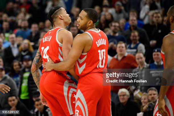 Gerald Green of the Houston Rockets is held back by teammate Eric Gordon after an altercation with Gorgui Dieng of the Minnesota Timberwolves during...