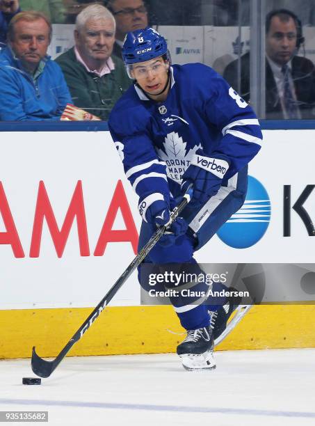 Connor Carrick of the Toronto Maple Leafs skates with the puck against the Montreal Canadiens during an NHL game at the Air Canada Centre on March...