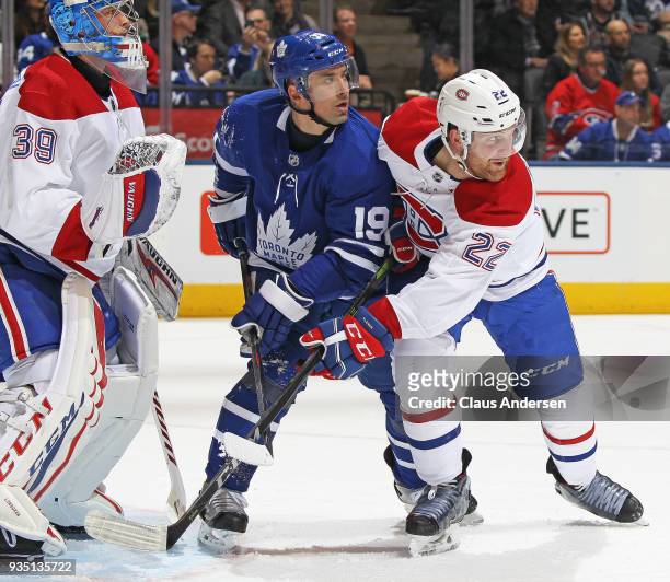 Tomas Plekanec of the Toronto Maple Leafs battles between Charlie Lindgren and Karl Alzner of the Montreal Canadiens during an NHL game at the Air...