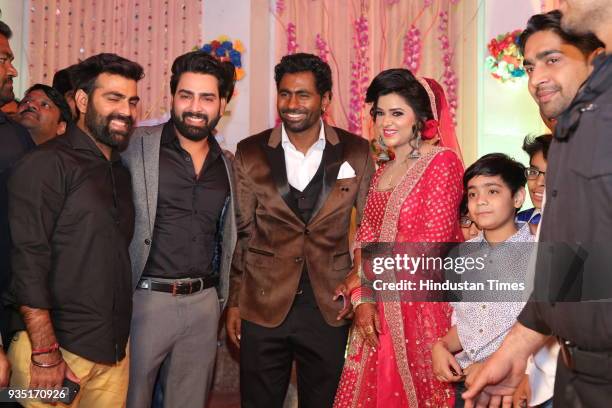 Reality show winner Manveer Gujjar with Indian cricketer Parvinder Awana and Sangit Awana during their wedding reception at Shiv Garden on March 10,...