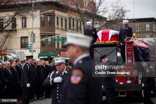 Members of the New York City fire department escort the casket of firefighter Thomas Phelan to St. Michael's Church in the Sunset Park neighborhood...