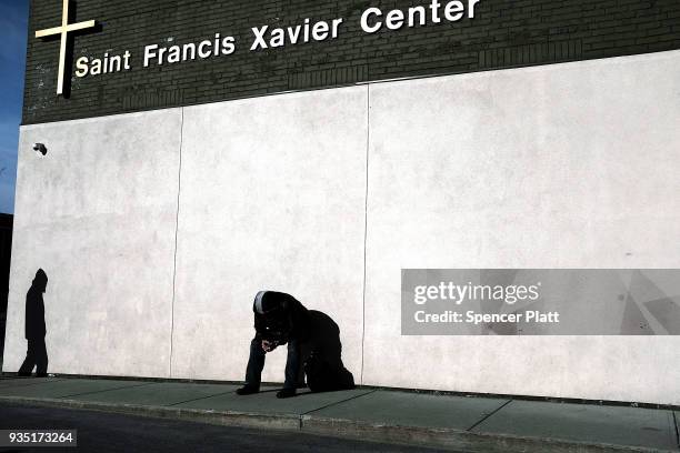 Men wait outside of a soup kitchen in an economically stressed section of the city on March 20, 2018 in Worcester, Massachusetts. Worcester, once a...