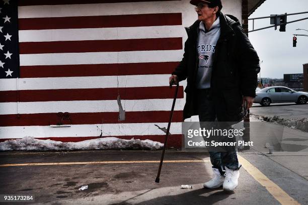 Man walks through an economically stressed section of the city on March 20, 2018 in Worcester, Massachusetts. Worcester, once a thriving...