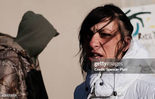 Julie, who struggles with addiction, pauses in an economically stressed section of the city on March 20, 2018 in Worcester, Massachusetts. Worcester,...