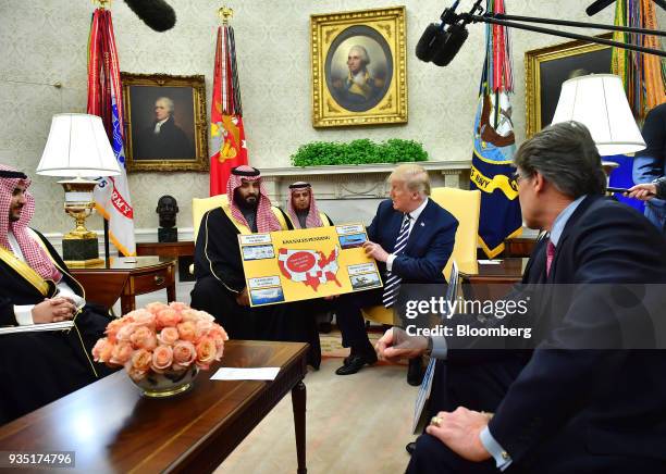President Donald Trump, center right, holds a chart displaying military sales during a meeting with Mohammed bin Salman, Saudi Arabia's crown prince,...