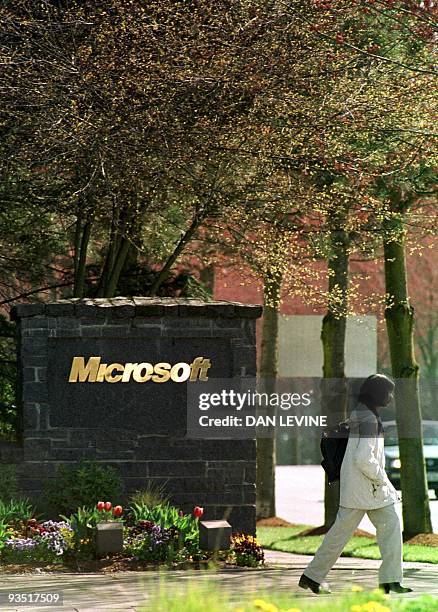 Woman passes by the entrance to the Microsoft campus 03 April 2000 in Redmond, WA, prior to the Justice Department's announcement regarding the...