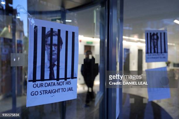 Posters depicting Cambridge Analytica's CEO Alexander Nix behind bars, with the slogan "Our Data Not His. Go Straight To Jail" are pictured at the...