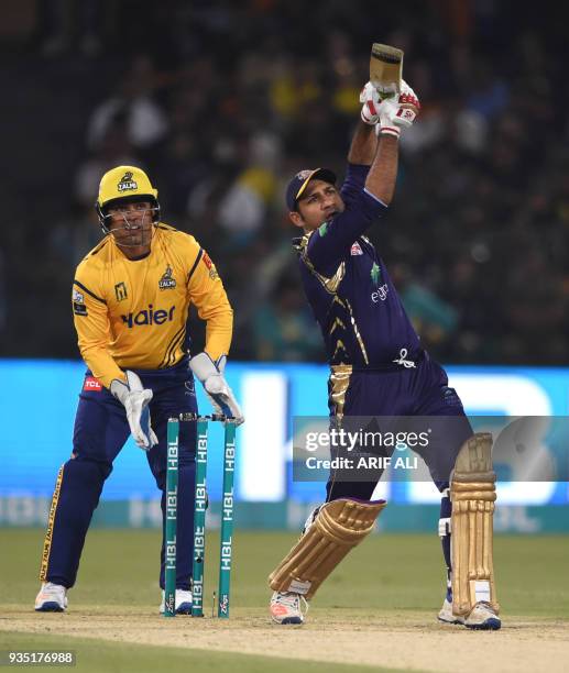 Sarfraz Ahmed from Quetta Gladiators views the ball after hitting against Peshawar Zalmi during the PSL T20 cricket match in the Gaddafi Stadium in...