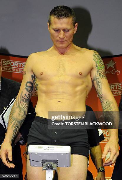 Australian titleholder Danny Green checks the scales during his weigh-in on the eve of his IBO cruiserweight World Title bout against four-division...