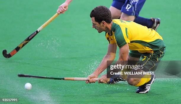 Australian player Jamie Dwyer attempts a shot on the English goal during their Champions Trophy field hockey match in Melbourne on December 1, 2009....