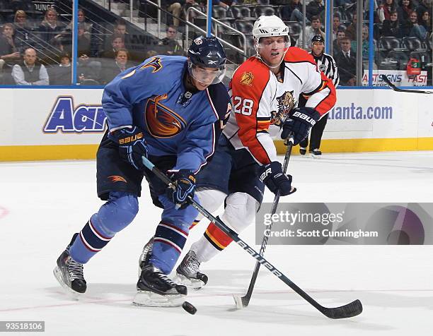 Evander Kane of the Atlanta Thrashers battles for the puck against Kamil Kreps of the Florida Panthers at Philips Arena on November 30, 2009 in...
