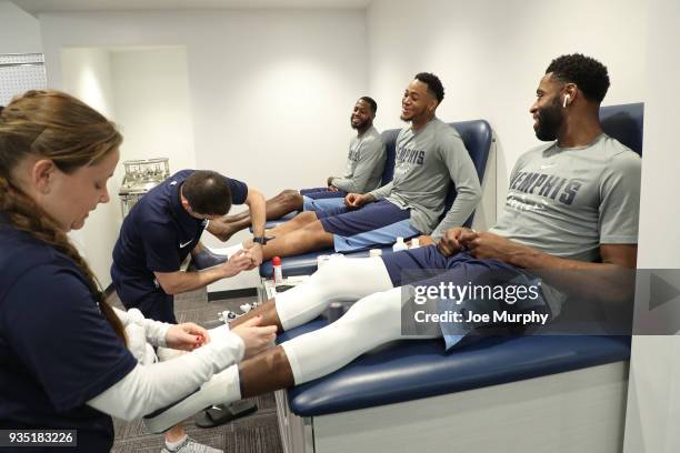 JaMychal Green, Jarell Martin and Tyreke Evans of the Memphis Grizzlies get treatment before the game against the Denver Nuggets on March 17, 2018 at...