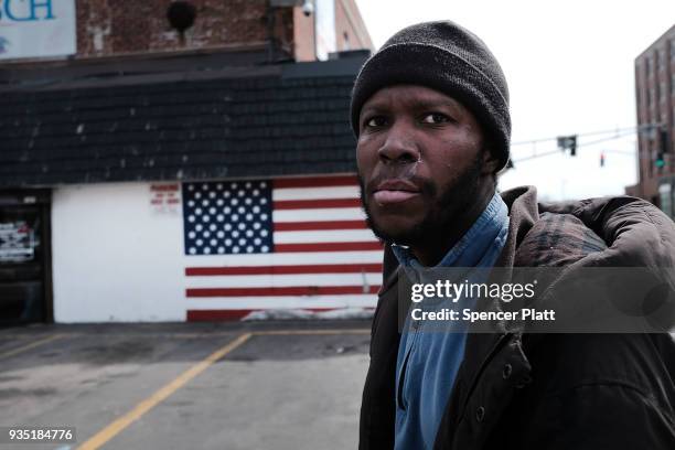 Bill, who is a military veteran and now homeless, walks through an economically stressed section of the city on March 20, 2018 in Worcester,...