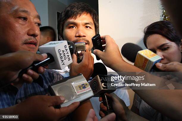 World boxing welterweight champion Manny Pacquiao is surrounded by the media after filing his candidacy at local election office, on December 1, 2009...