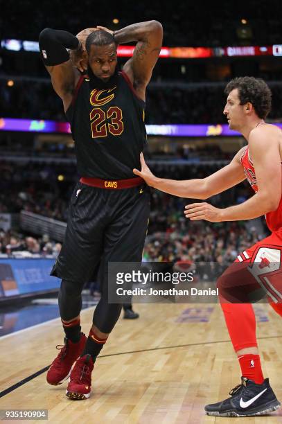LeBron James of the Cleveland Cavaliers moves against Paul Zipser of the Chicago Bulls at the United Center on March 17, 2018 in Chicago, Illinois....