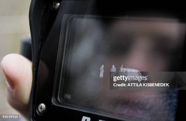 Hungarian border guard checks his thermal-imaging camera at the Hungarian and Ukrainian border near Beregsurany village in Hungary 19 December 2007....