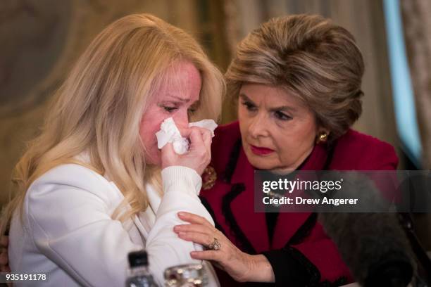 Rocxanne Deschamps is consoled by her attorney Gloria Allred during a press conference at the Lotte New York Palace Hotel, March 20, 2018 in New York...