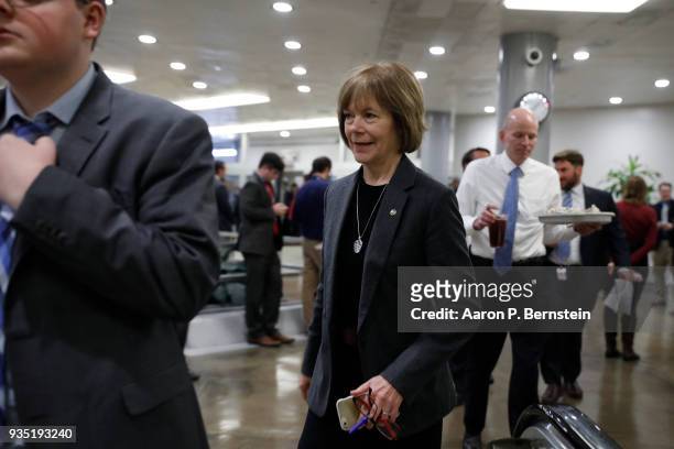 Sen. Tina Smith walks to the Capitol ahead of the weekly policy luncheons on Capitol Hill March 20, 2018 in Washington, DC. Congress faces a looming...