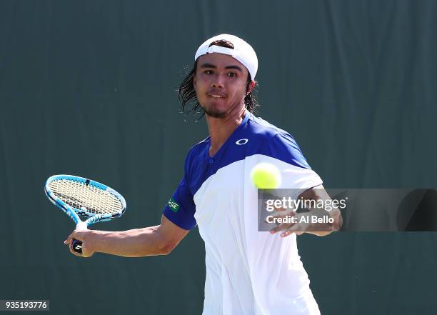 Daniel Taro plays a shot against Thanasi Kokkinakis of Australia during Day 2 of the Miami Open at the Crandon Park Tennis Center on March 19, 2018...