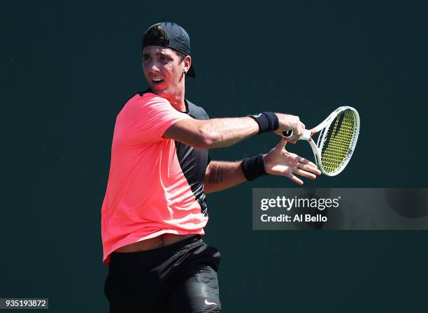 Thanasi Kokkinakis of Australia plays a shot against Daniel Taro of Japan during Day 2 of the Miami Open at the Crandon Park Tennis Center on March...