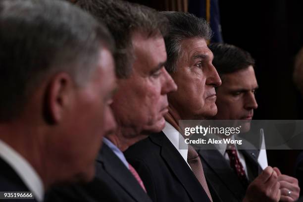 Sen. Joe Manchin listens during a news conference at the Capitol March 20, 2018 in Washington, DC. The committee held a news conference to present...