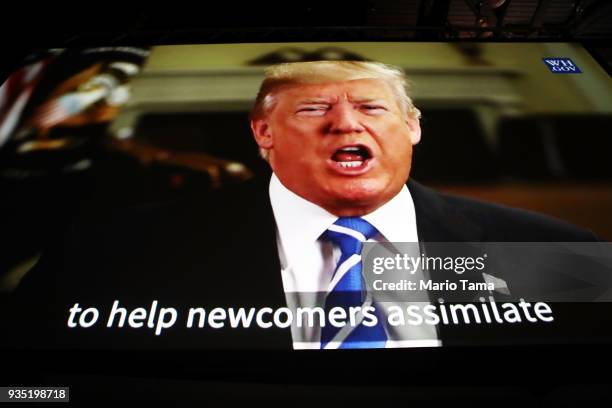 Recorded video message from U.S. President Donald Trump is played on a video screen at a naturalization ceremony on March 20, 2018 in Los Angeles,...