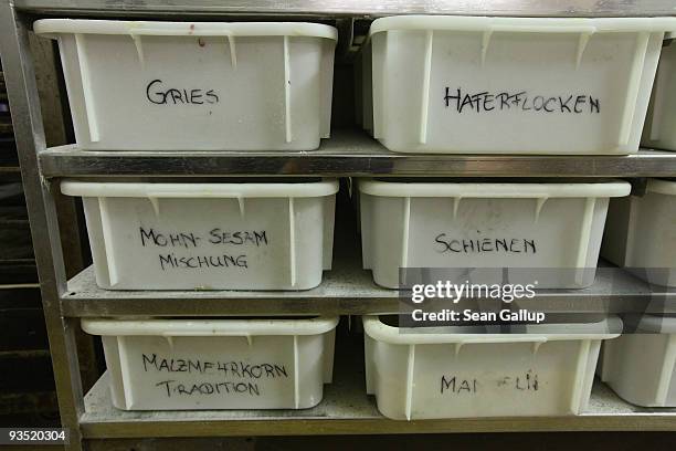 Boxes of ingredients, including poppy seed and almonds for Christmas stollen loaves and cake, lie in shelves at the Muehlenbaeckerei bakery on...