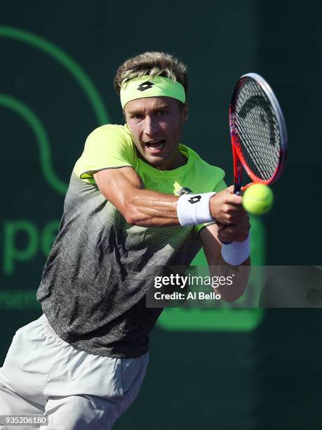 Liam Brody of Great Britain plays a backhand against Filip Peliwo of Canada during Day 2 of the Miami Open at the Crandon Park Tennis Center on March...